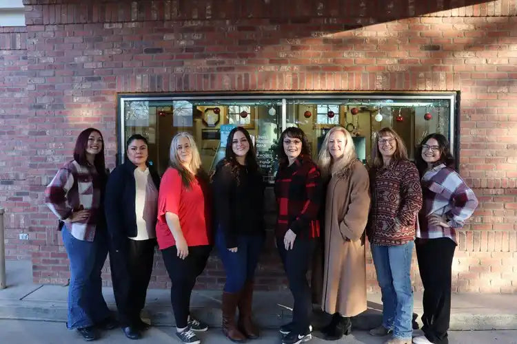 Red plaid coat with black buttons and pockets, made of wool.