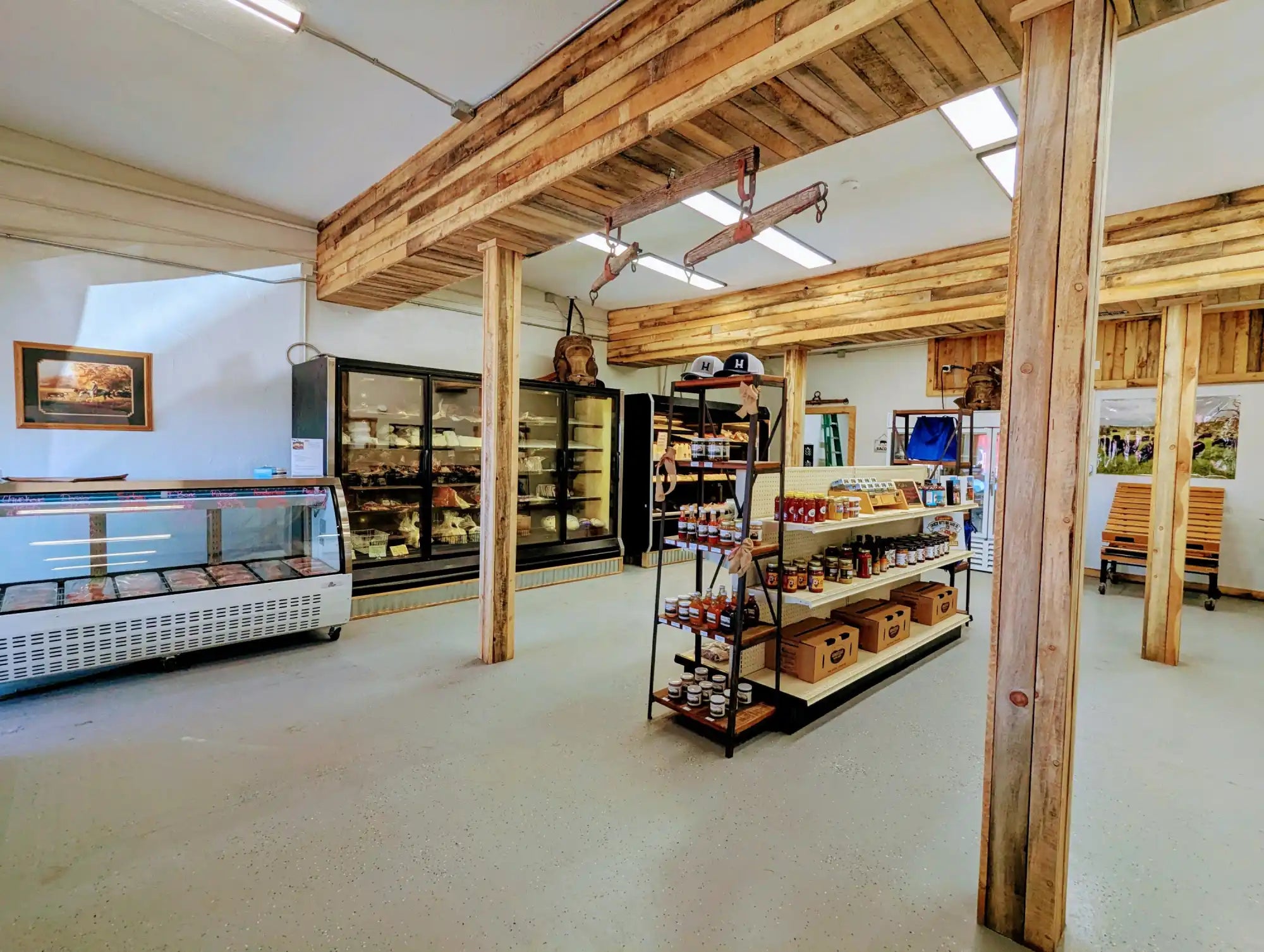 Wooden bakery display case with glass front and metal frame.